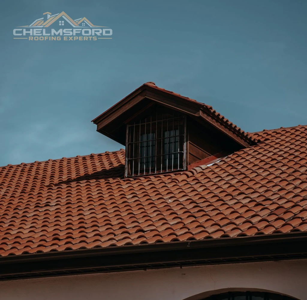 Red clay tiled roof with a small dormer window