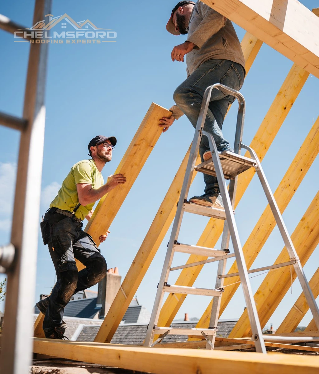 Two roofers assembling a timber roof frame