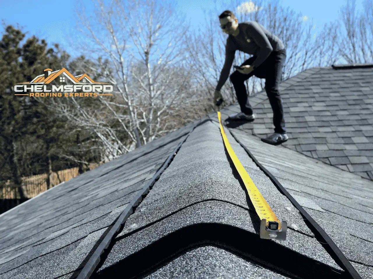 Roofer measuring along the ridge of a pitched roof