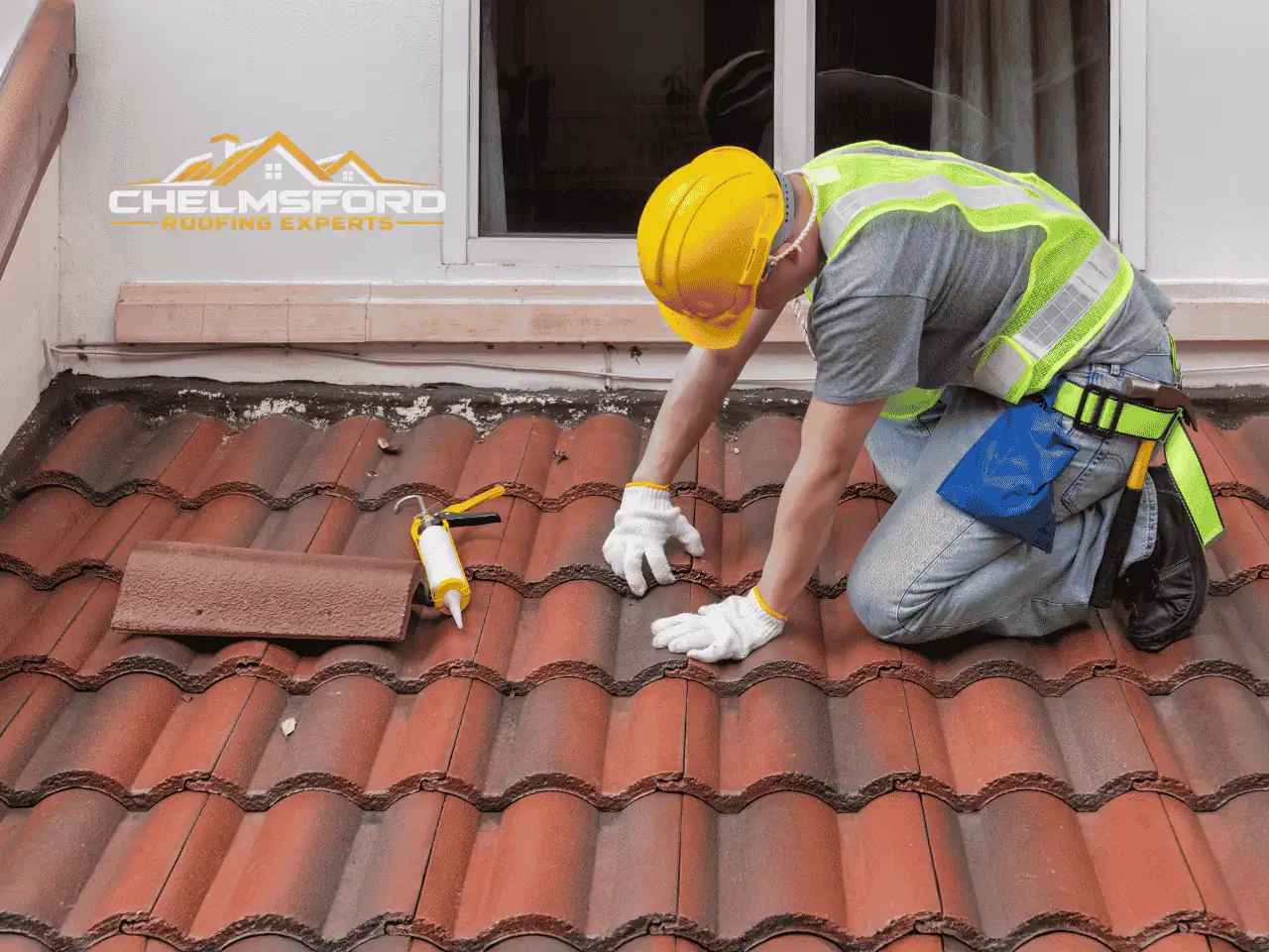Roofer inspecting concrete tiles on a pitched roof