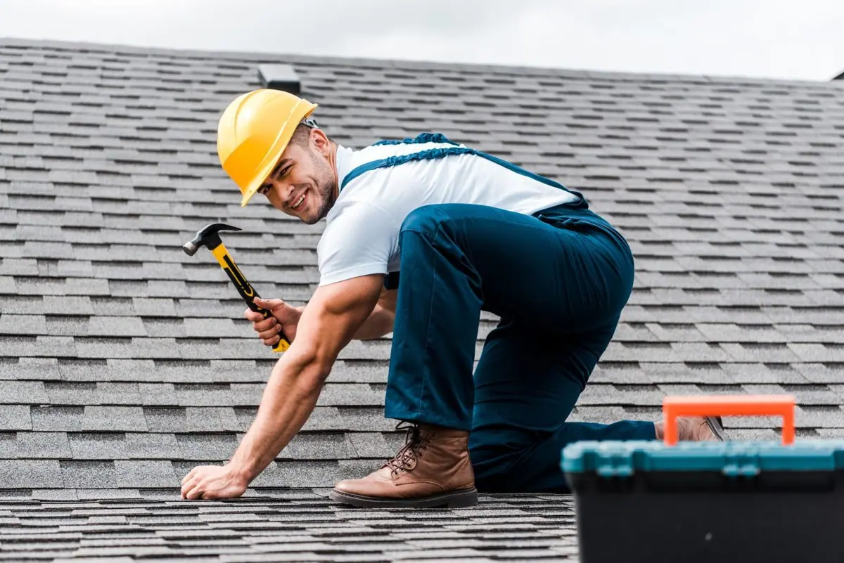 Illustrative worker checking overlapping dark roof coverings with hand tools - projects / case studies roofing guidance for Chelmsford, Essex