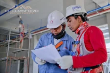 Two construction workers reviewing plans on site